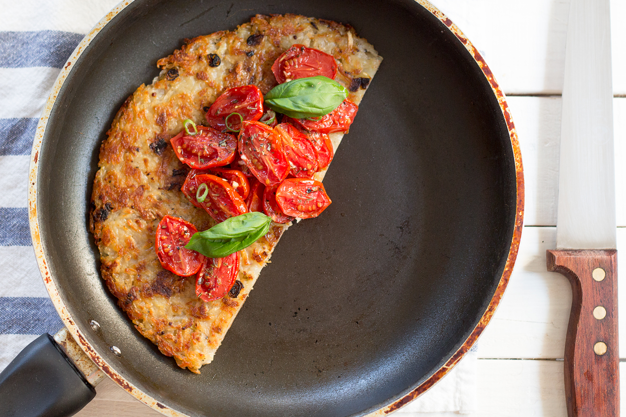 shredded potato rösti topped with garlicky tomatoes half