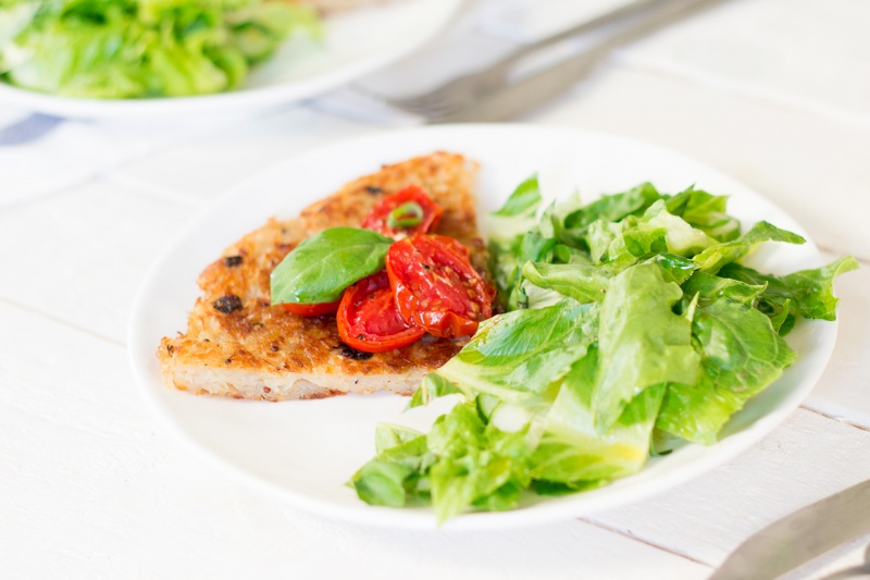 shredded potato rosti topped with garlicky tomatoes portion