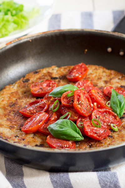 Shredded potato r sti topped with garlicky tomatoes