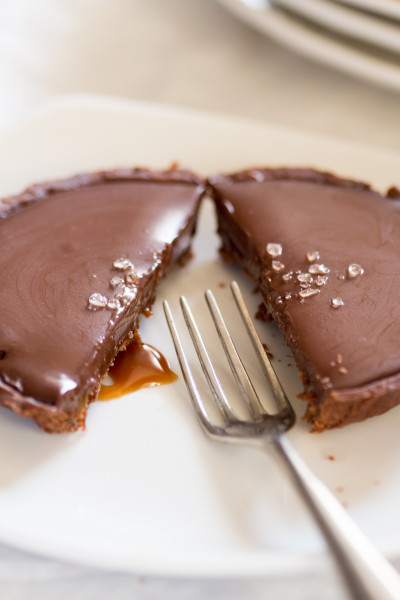 vegan chocolate and salted caramel tart cut in half