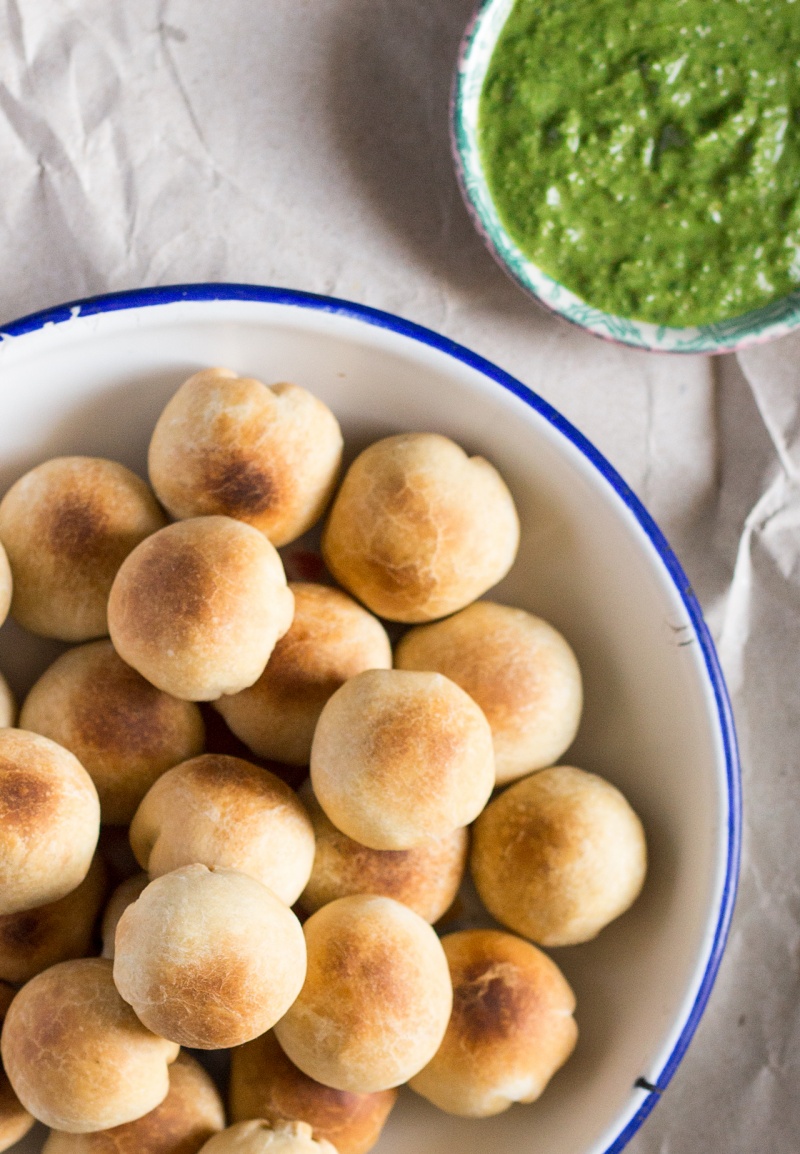 a bowl of baked pea kachori with coriander chutney