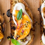 Vegan crostini with smoky white bean spread and nectarine-image