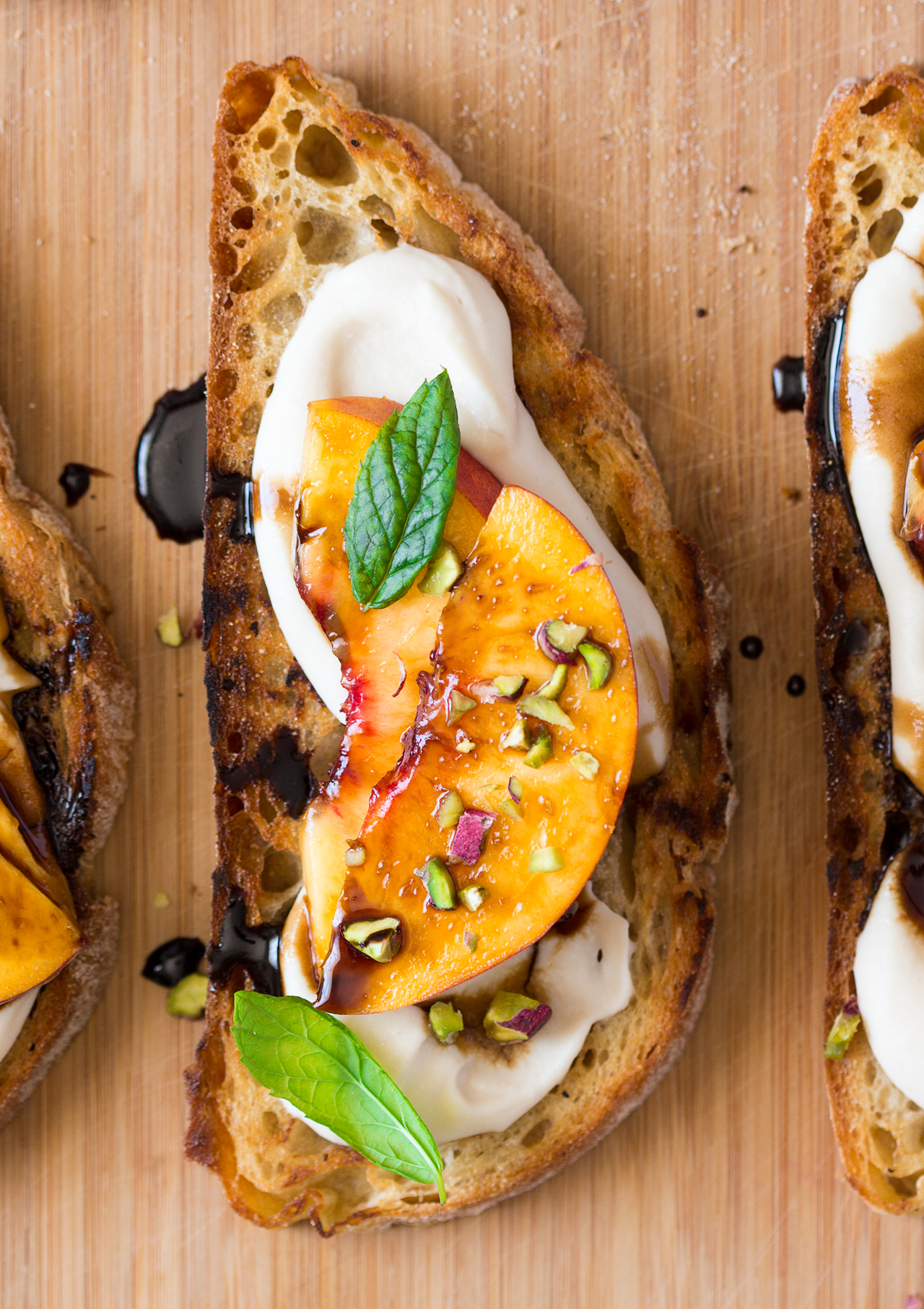 Vegan crostini with smoky white bean spread and nectarine Lazy Cat