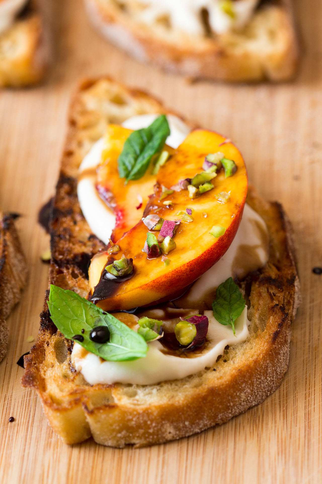 Vegan crostini with smoky white bean spread and nectarine Lazy Cat