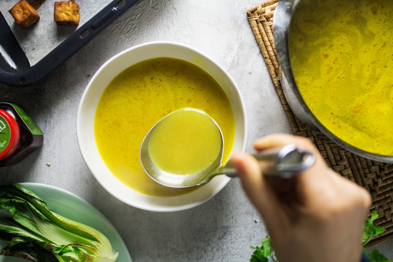 ginger turmeric broth pouring