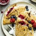 Vegan crêpes with vanilla cream and berries-image