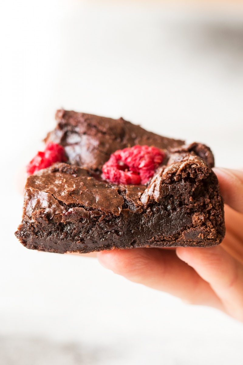 vegan raspberry brownies piece held