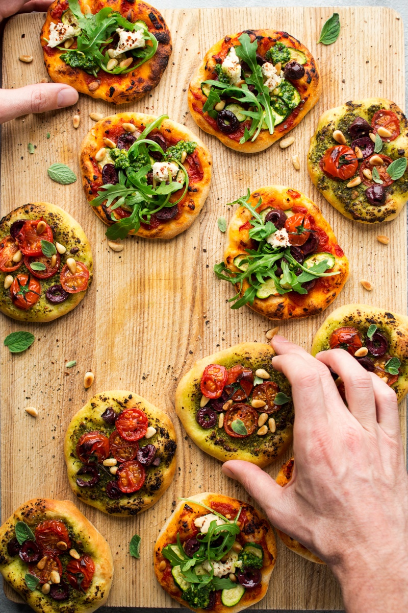 mini vegan pizzas hands