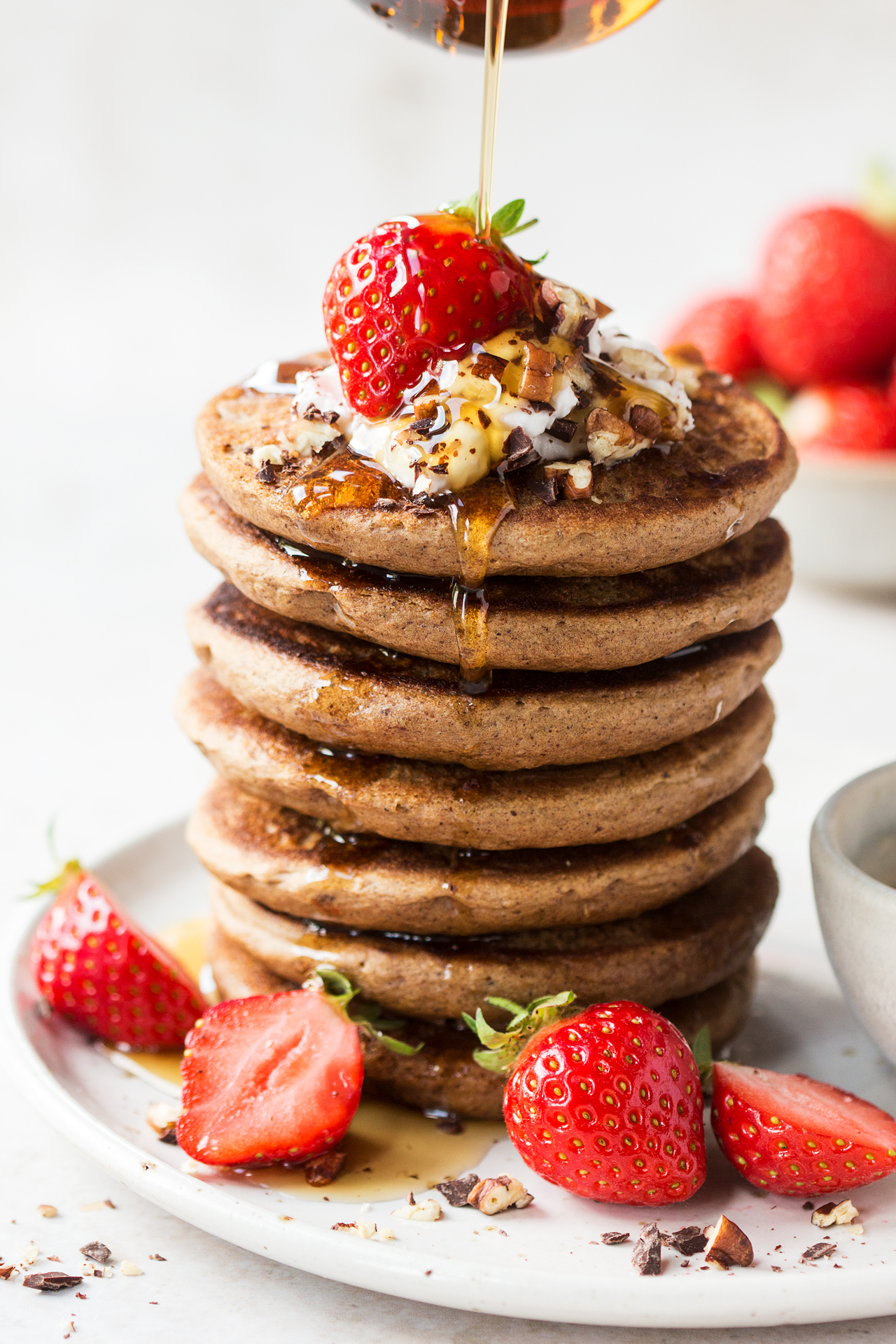 vegan buckwheat pancakes stack pouring syrup