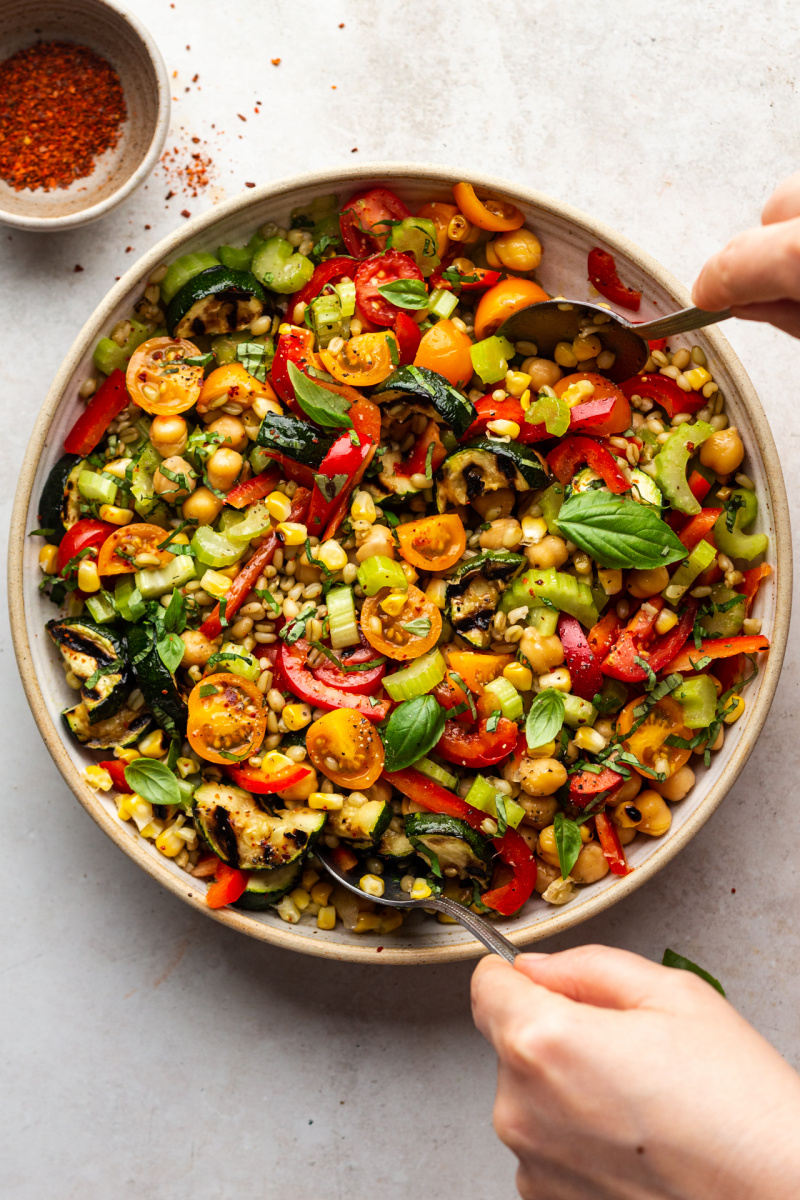 summer farro salad mixing